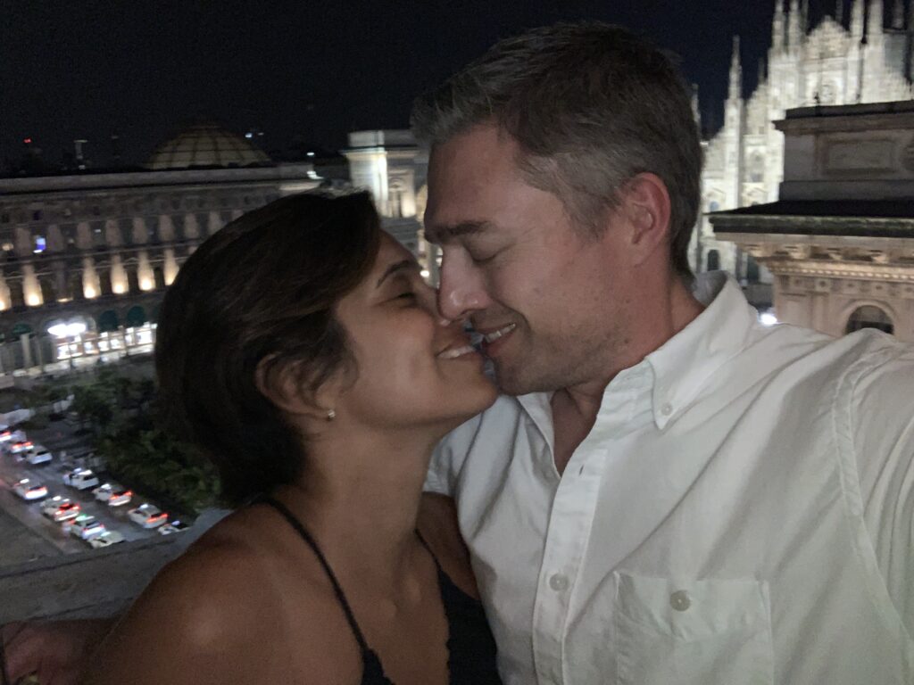 Daisy and Christopher kissing at the Duomo di Milano.